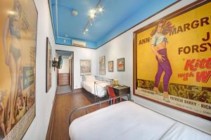 a room with a bed and a movie poster at Chelsea Pines Inn in New York