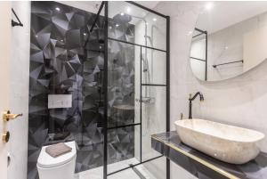 a bathroom with a large sink and a shower at Victory VIP apartments in Kallithea Halkidikis +13 photos