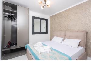 a bedroom with a bed with towels on it at Victory VIP apartments in Kallithea Halkidikis