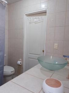 a bathroom with a bowl sink and a toilet at Casa Jasso in Guanajuato