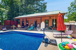 a backyard with a pool and a house with a basketball hoop at Bohemian Hideaway in Muscle Shoals