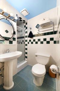 a bathroom with a toilet and a sink at Chelsea Pines Inn in New York