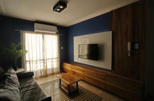 a living room with a couch and a flat screen tv at Cipres 4 B in San Miguel de Tucumán