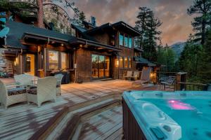 a house with a deck with a hot tub at Bronson by AvantStay Luxurious Home On The Slopes in Olympic Valley