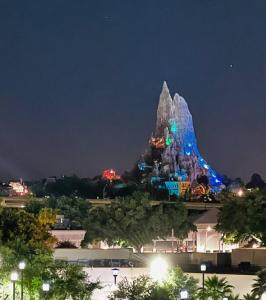 a disneyland attraction at night with a castle at Cozy Getaway in Orlando