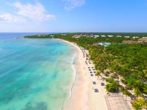 an aerial view of a beach with palm trees and the ocean at Grand Palladium Colonial Resort & Spa - All Inclusive in Akumal
