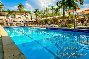 a large swimming pool with chairs and umbrellas at diRoma Fiori RM Hospedagem in Caldas Novas