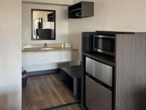 a small bathroom with a sink and a microwave at Motel 6-Cedar Rapids, IA in Cedar Rapids
