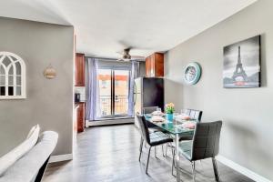 a kitchen and dining room with a table and chairs at Modern 2BR - King Bed Apartment - PRIME Location in Hamilton