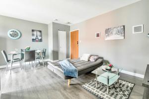 a living room with a couch and a table at Modern 2BR - King Bed Apartment - PRIME Location in Hamilton