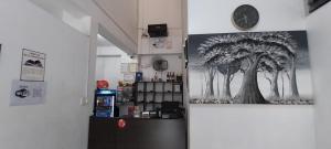 a coffee shop with a tree painting on the wall at Hospedaje Moralillos in Yurimaguas
