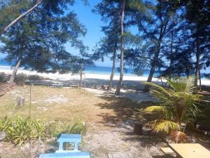 a view of a beach with trees and the ocean at Chalet Ombak Rindu Kudat in Tiga Papan +2 photos