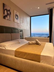 a bedroom with a large bed with a large window at Z art Hotel in Krujë