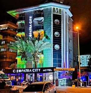 a city at night with a large building at Cleopatra City Hotel in Alanya