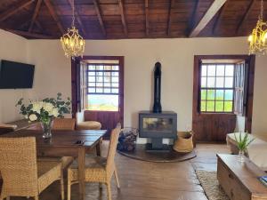 a living room with a table and a fireplace at Auténtica Casa Rústica Canaria in Puntagorda +17 photos