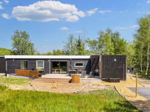 a black tiny house with a courtyard at 5 star holiday home in Øster Assels-By Traum in Øster Assels