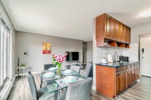 a kitchen and living room with a table and chairs at Spacious 2BR Apt - Near DT Hamilton in Hamilton