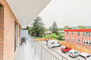 a balcony with cars parked in a parking lot at Spacious 2BR Apt - Near DT Hamilton in Hamilton