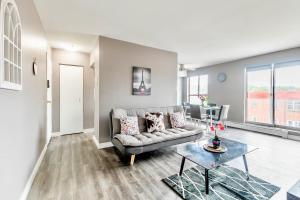a living room with a couch and a table at Spacious 2BR Apt - Near DT Hamilton in Hamilton