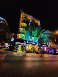 a city at night with a building at Cleopatra City Hotel in Alanya