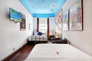 a hospital room with two beds and a flat screen tv at Chelsea Pines Inn in New York
