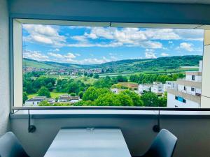a large window with a view of a city at Freshly renovated Studio apartment - top location in Weinstadt in Weinstadt