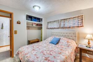 a bedroom with a bed with a blue pillow on it at Lakefront Family Retreat with Private Dock! in Rice Lake