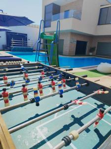 a row of trampolines in a swimming pool at Tala DeadSea Villa in Sowayma