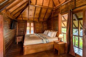 Tempat tidur dalam kamar di Tahlia's Villa
