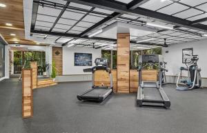 a gym with two treadmills and two exercise bikes at Oceanview Retreat - Steps to the Beach and 2 Pools in Oceanside