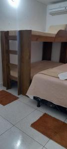 a bedroom with a bunk bed and a desk at Hospedaria Temporarte in Piranhas