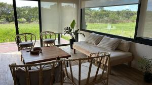 a living room with a couch and a table and chairs at Casa Nera in Chapadmalal