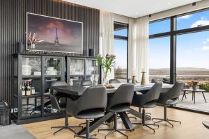 a dining room with a table and chairs at Spacious 4BR Summerhouse With Hot Tub in Reykholt