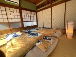 Postel nebo postele na pokoji v ubytování 農家古民家ねこざえもん奥屋敷 Nekozaemon-Gest house