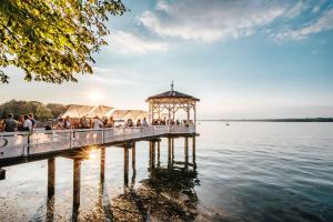 einen Pavillon auf einem Pier auf einem See in der Unterkunft Stilvolle Gartenterrassenwohnung mitten in Bregenz in Bregenz