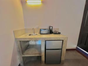 a counter with a sink in a room at Hotel Citadin Z10 in Guatemala