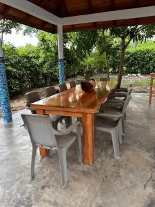 a wooden table with chairs and a bowl on top at Casa Boutique Rincon in San Onofre