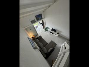 an overhead view of a living room with a couch at Duplex piscine vue imprenable Marina du Gosier avec citerne in Le Gosier