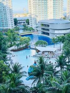 a large pool in a city with people in it at Azure Urban Residences in Manila