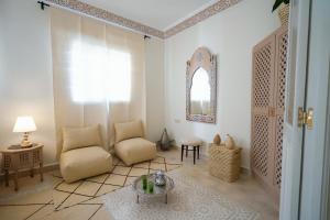 a living room with a chair and a table at Dar Badr in Tangier +37 photos