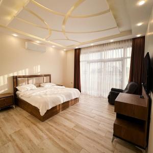 a bedroom with a bed and a large window at Waves Chalet in Al Mazār