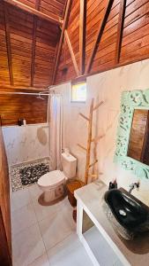 a bathroom with a toilet and a sink at Volcano Valley in Kintamani