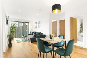 a living room with a table and chairs and a couch at Pluxa Emerald Luxury - Walk to Attractions, Transport Nearby in Birmingham +12 photos
