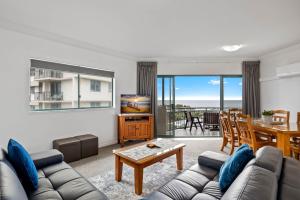 a living room with a couch and a table at Sunshine Towers Boutique Apartments in Maroochydore
