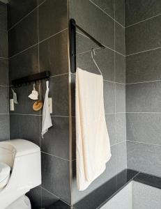a bathroom with a toilet and a shower with a towel at 礁溪樂沐L’Amour in Yü-shih-ts'un