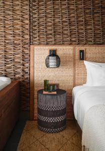 a bedroom with a bed and a table next to a bed at 1 Hotel Hanalei Bay in Princeville