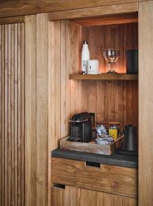 a kitchen with wood paneling and a counter with a wine glass at 1 Hotel Hanalei Bay in Princeville