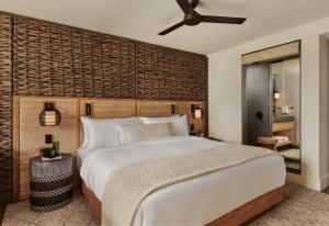 a bedroom with a large bed and a ceiling fan at 1 Hotel Hanalei Bay in Princeville