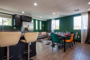 a dining room with green walls and a table and chairs at Spacious Luxury Villas in the heart of LA! Free parking and Jacuzzi in Los Angeles