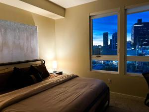 a bedroom with a bed with a view of a city at Beautiful Home in LA - Parking 10 Min To Cedars in Los Angeles +34 photos